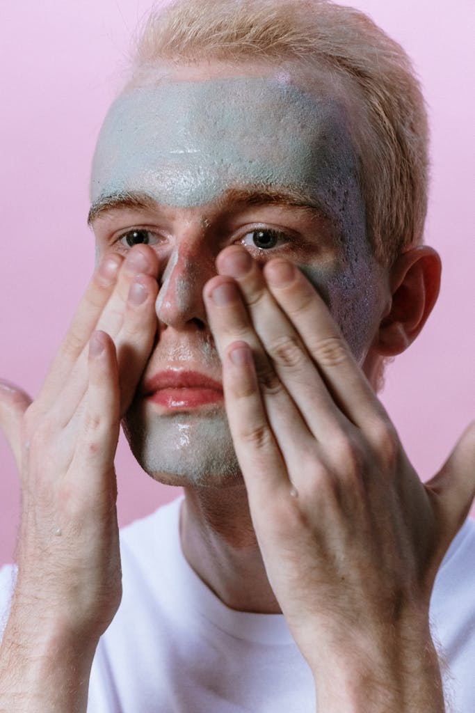 Man in White Shirt Covering His Face With His Hand