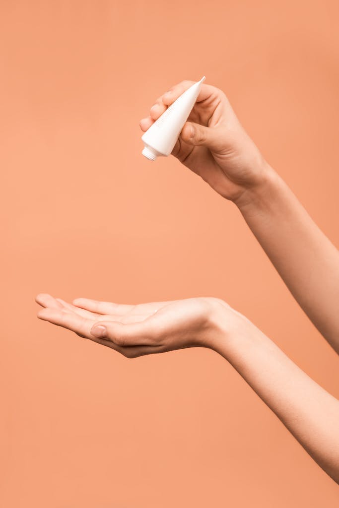 Person Holding White Plastic Tube